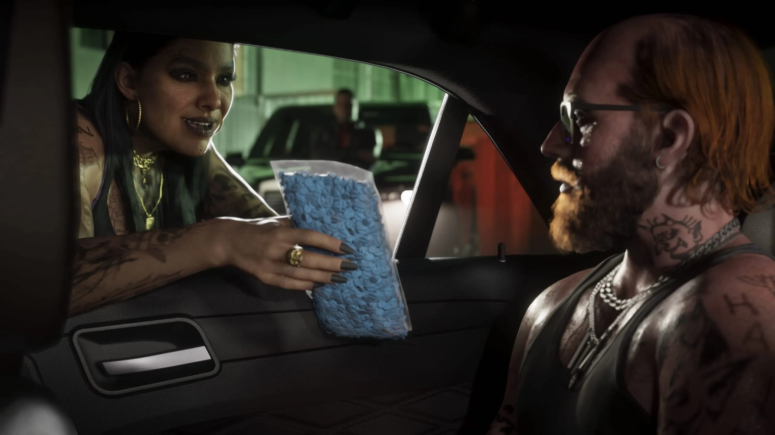 Tattooed woman leans through a car window handing a bag of blue pills to a bearded red-haired driver
